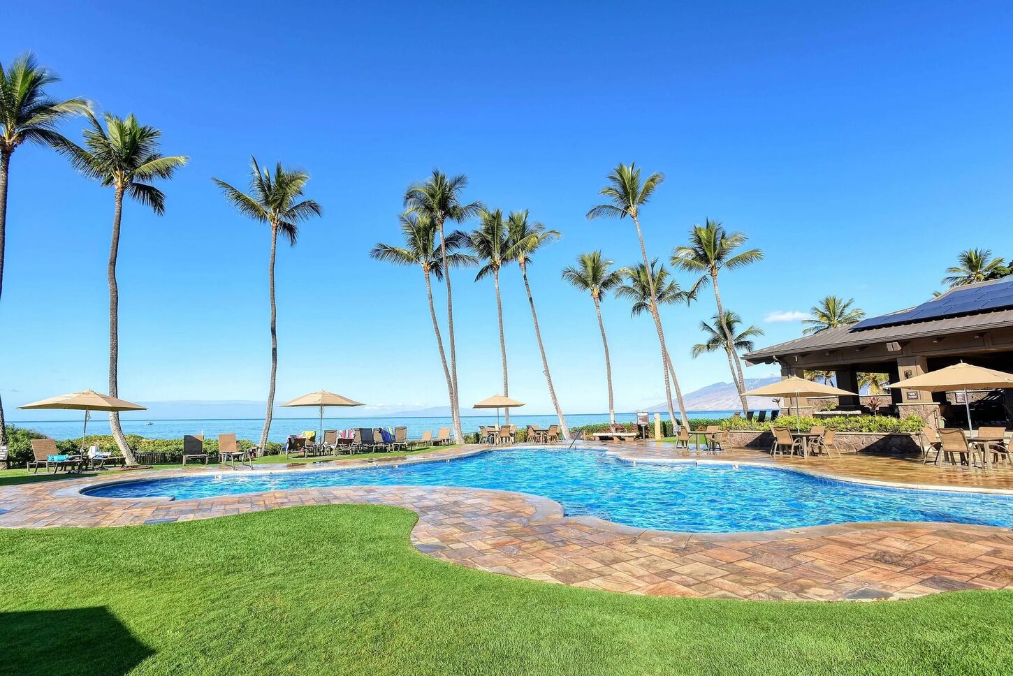 Wailea Ekahi oceanfront pool and grounds with palm trees overlooking the Pacific Ocean