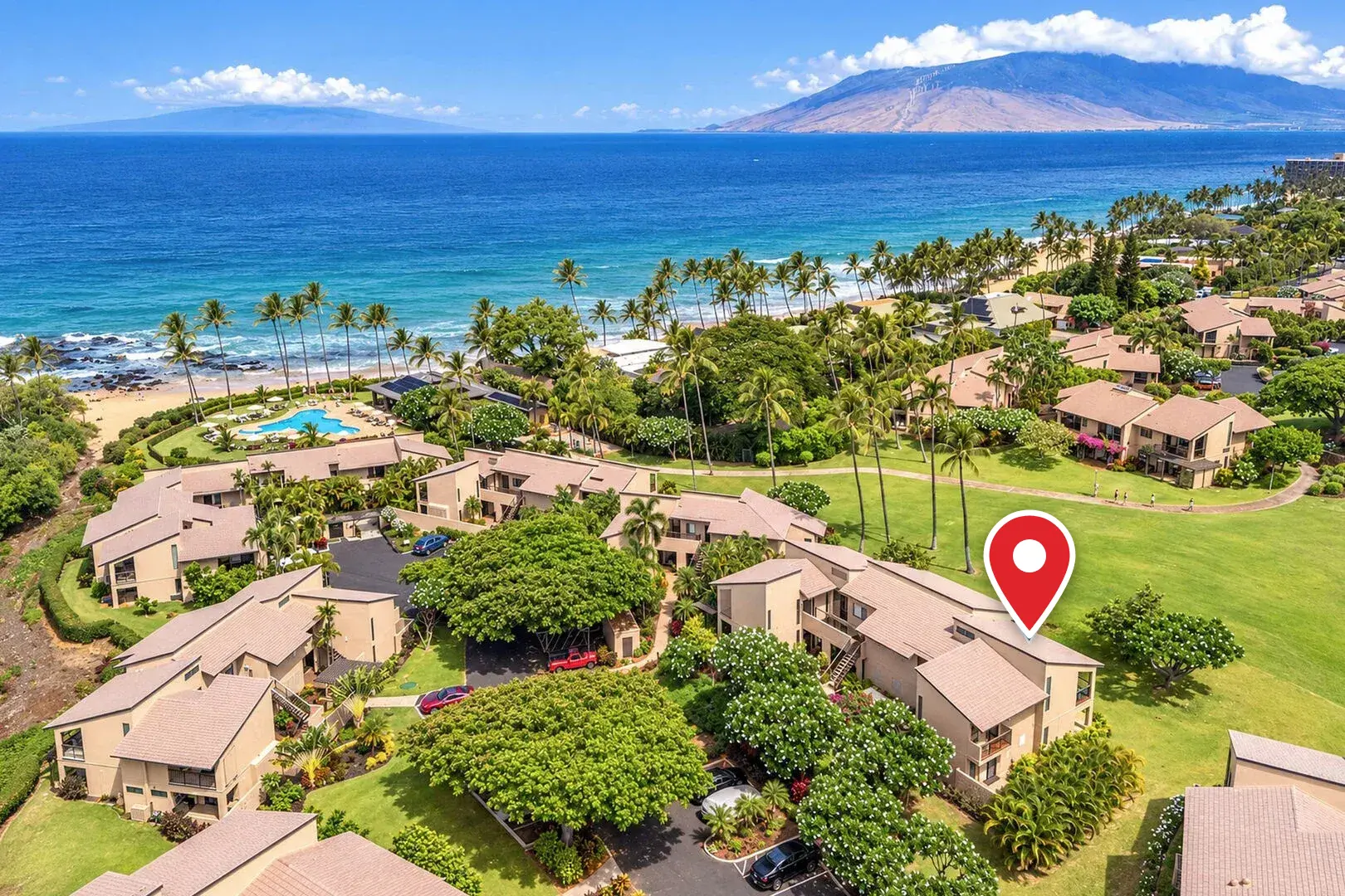 Aerial view of Wailea Ekahi Village and the ocean with a red pin marking unit 10F