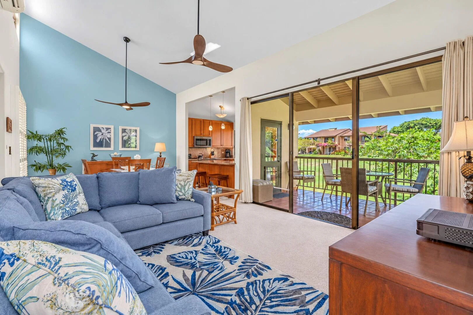 Dining area with blue accent wall and kitchen breakfast bar