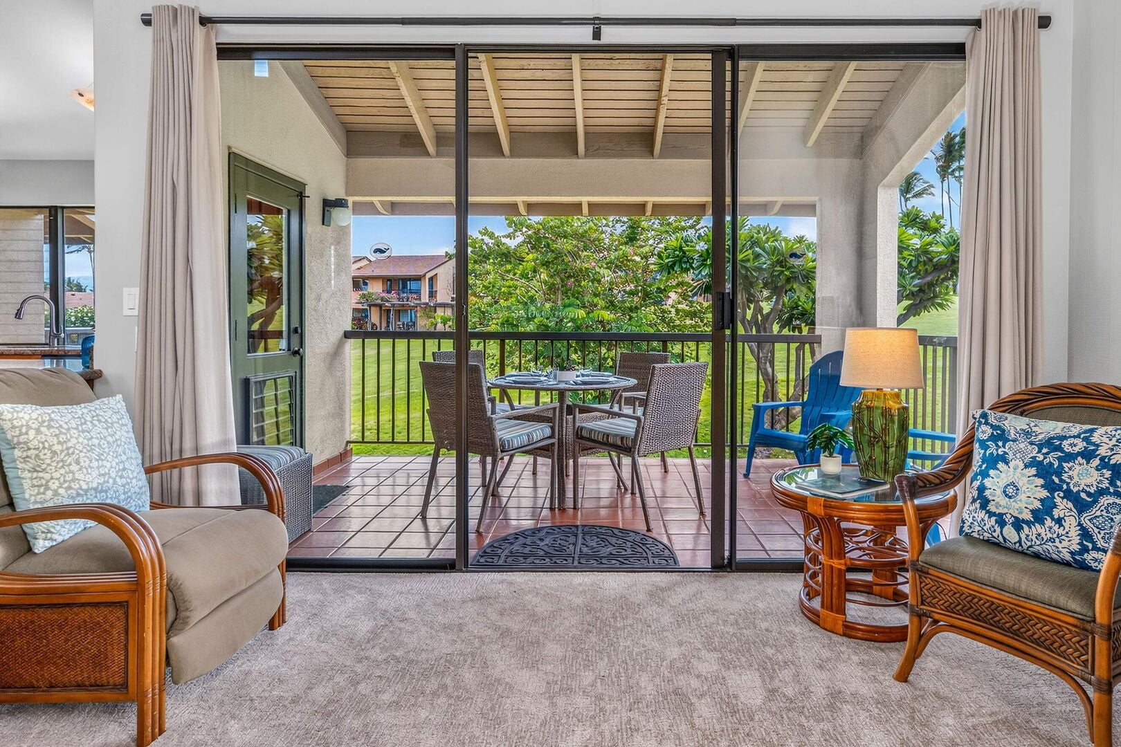 Living room at Wailea Ekahi 10F opening onto the private lanai with garden views