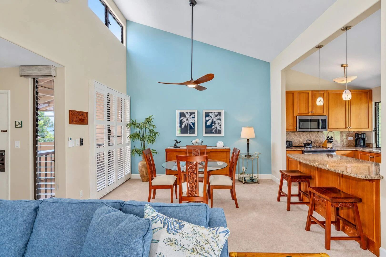 Open living, dining, and kitchen area with vaulted ceilings
