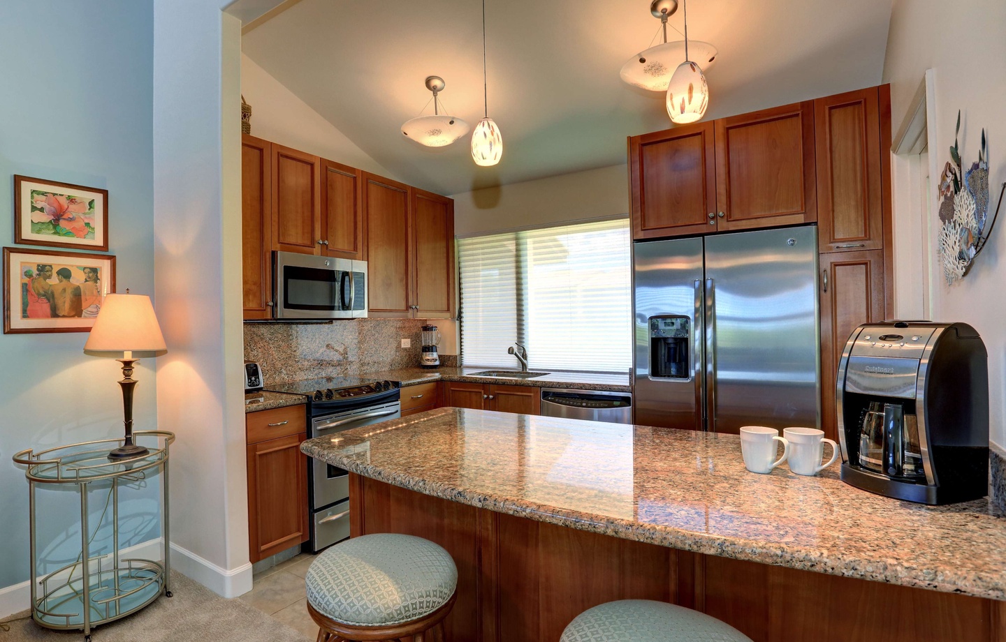 Full kitchen at Wailea Ekahi 10F with granite counters, stainless appliances, and breakfast bar